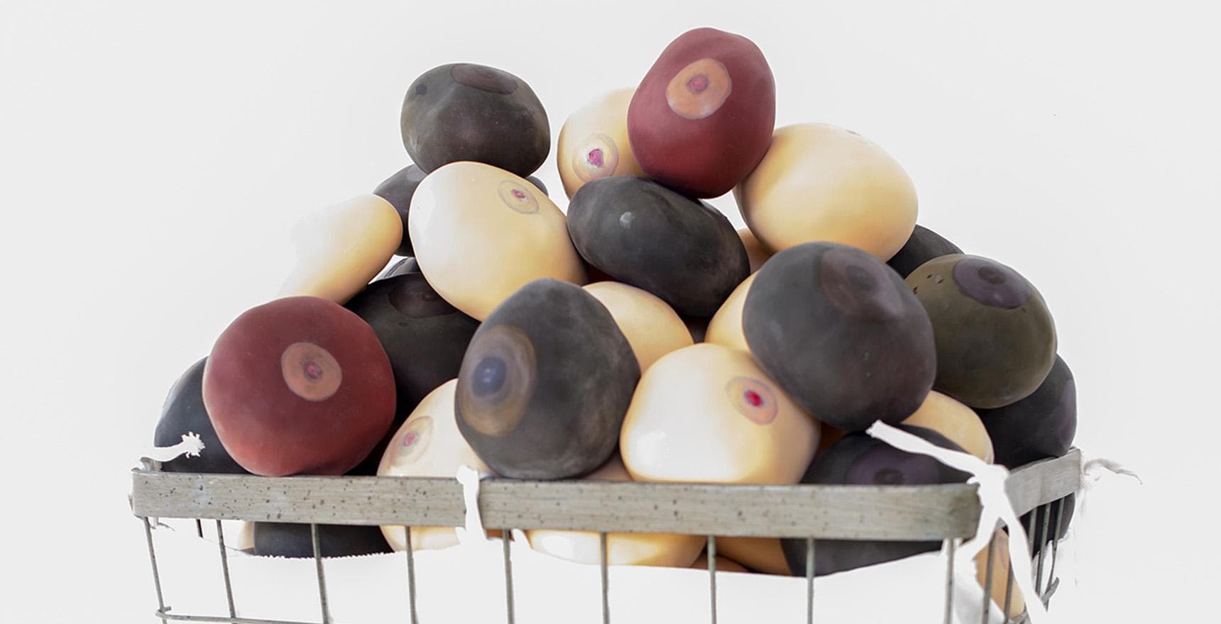 a basket of rocks with painted eyes