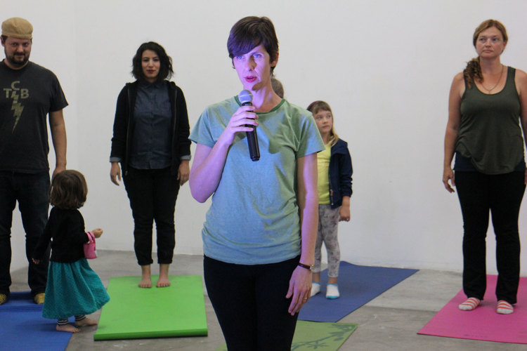 adults and children in a yoga studio