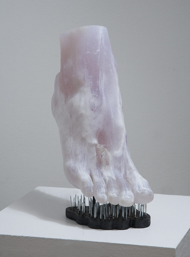Sculpture of a foot stepping on nails