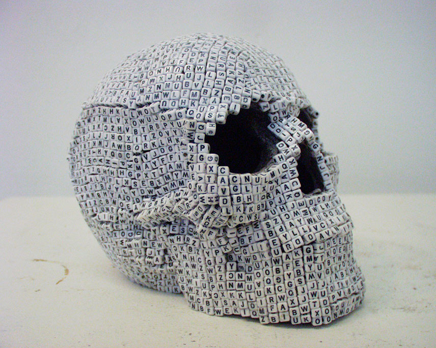 skull sculpture made of lettered dice