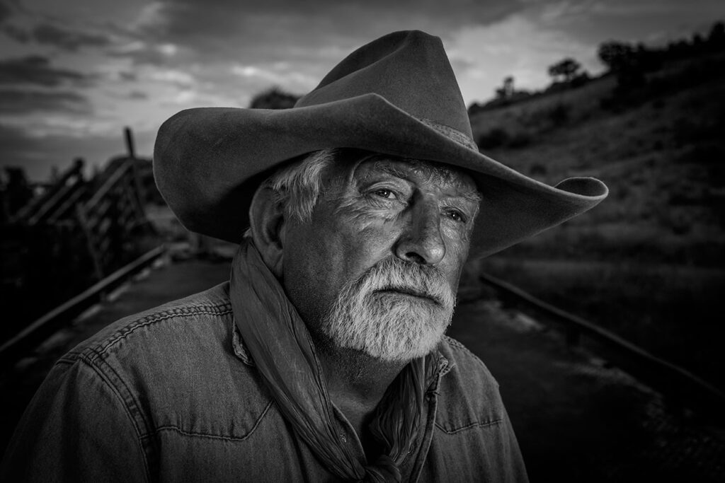 Black and white photo of an elderly man in a cowboy hat