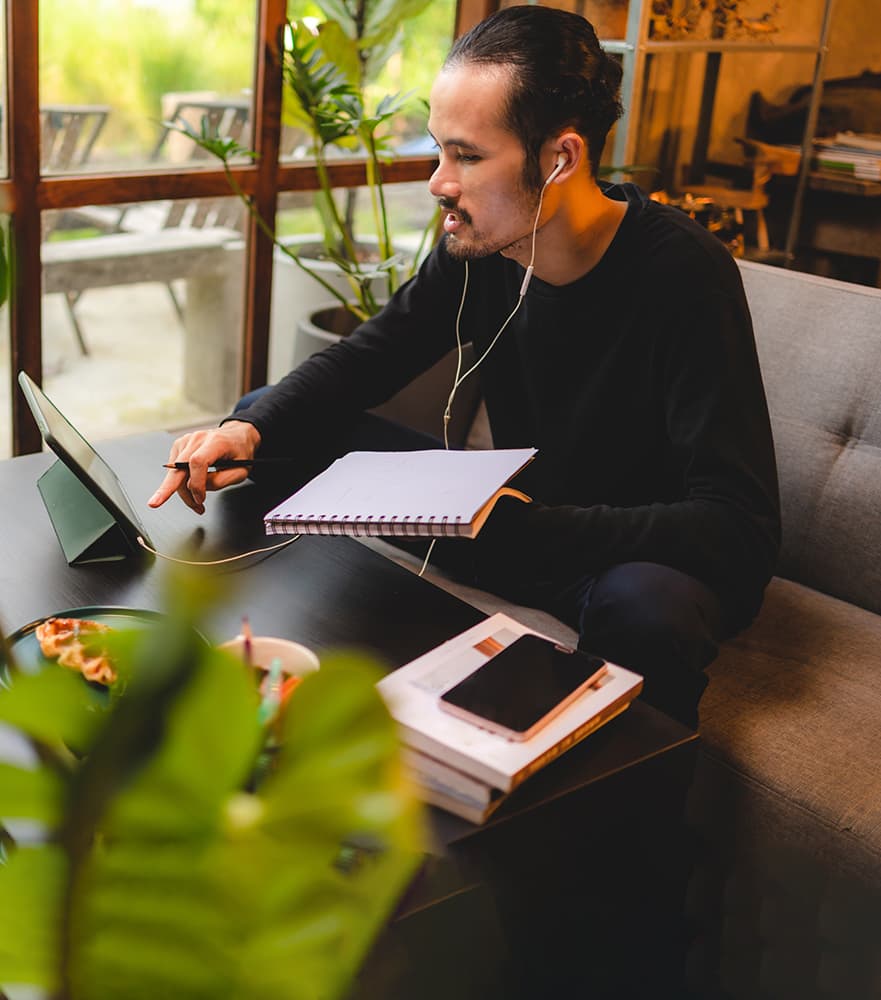 A young man researching financial aid on a tablet computer