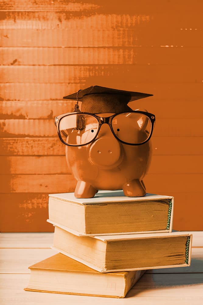 A piggy bank on top of books