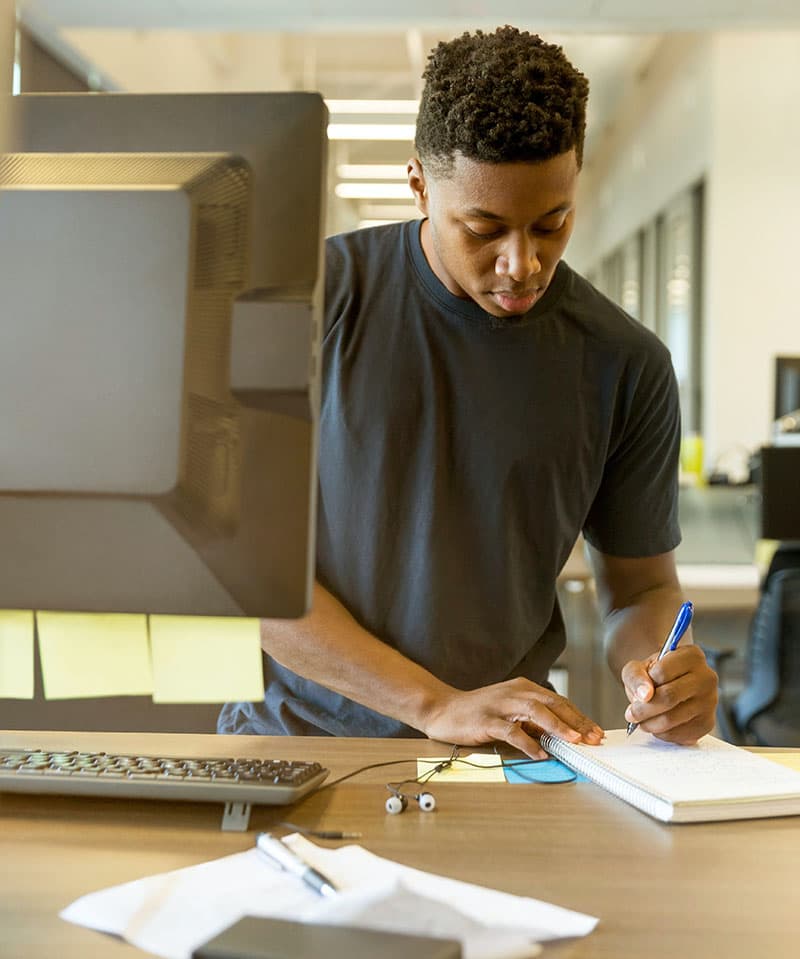A young man doing paperwork for financial aid for college