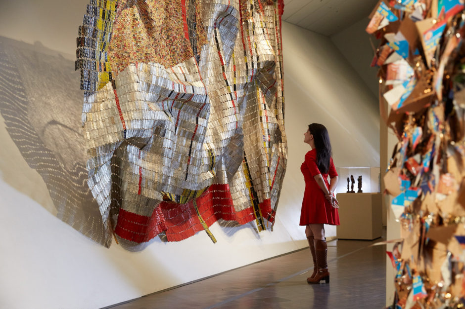 Woman admiring textile work on display at Denver Art Museum