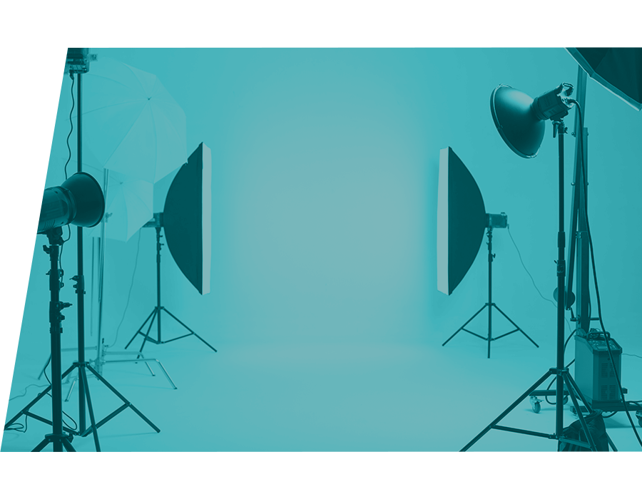 A photography studio with lights and an empty white wall