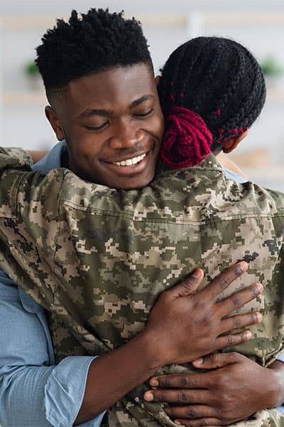 Husband hugging his military wife.