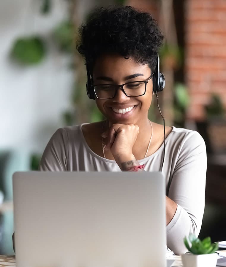 An online student attending a virtual class on her laptop.