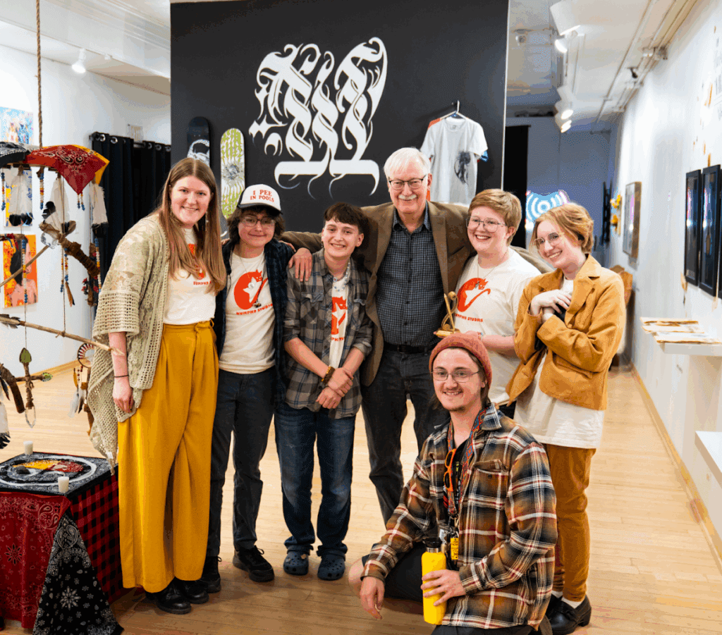 John Musker posing with the Bumpko Studios team along with fellow RMCAD students.