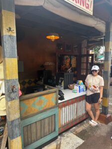 Alyssa Sorensen in front of a check-out counter she designed at Disney World.